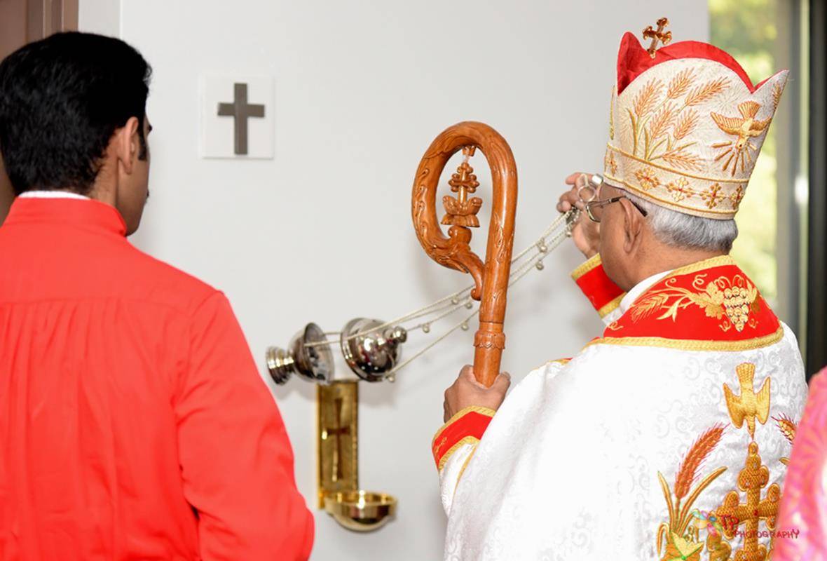 Bishop Jacob Angadiath censes one of four crosses marking the walls of St. Mary's Syro-Malabar Church during its consecration July 22.