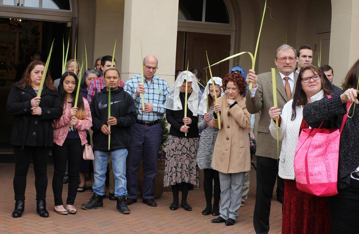 CHARLOTTE — People pray at the start of the outdoor procession for Palm Sunday at St. Ann Church. (SueAnn Howell, Catholic News Herald)