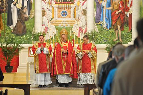 Immediately before the Mass at St. Ann Church, Father Kauth blessed the palms in the ancient ritual and then led a procession inside the church as the schola sang a hymn to Christ the King. (Photos provided by Markus Kuncoro)
