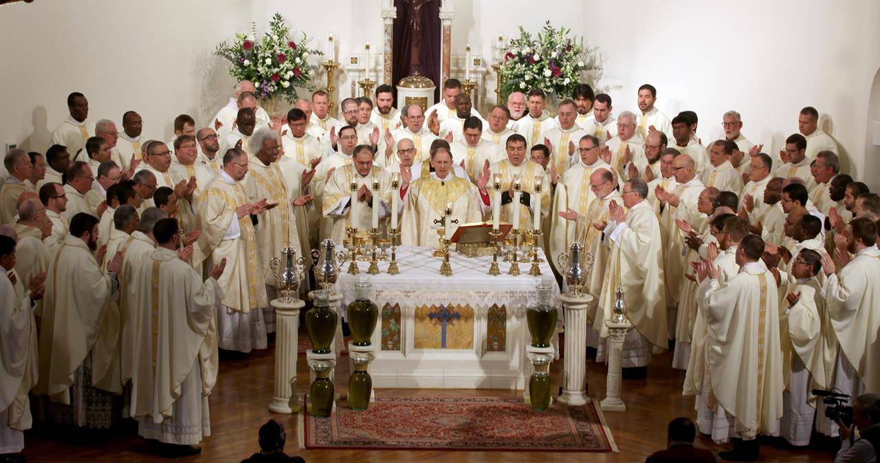 The priests gather around the altar with the bishop for the Liturgy of the Eucharist.