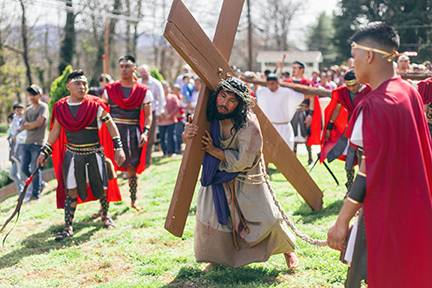 Jesus carries his cross during the Via Crucis at St. Charles Borromeo Church in Morganton (Photo by Lorenzo Pedro, correspondent)
