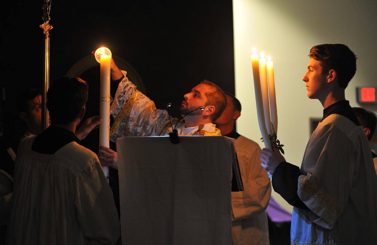 A Mass in the Extraordinary Form celebrated at Charlotte Catholic High School chapel began with the lighting of the ancient triple branch candlestick, representing the Trinity, while the deacon chanted Lumen Christi, or Light of Christ.
