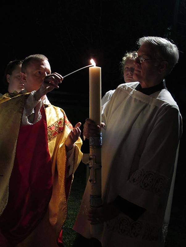 Fr. Casey Coleman lights the Paschal candle at St. Mary, Mother of God Church in Sylva (Photo by Della Sue Bryson, correspondent)