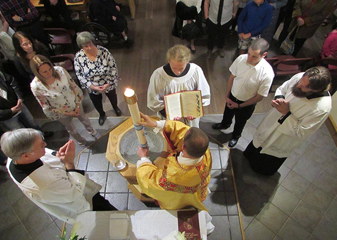 Fr. Coleman baptized two adults during the Easter Vigil at St. Mary, Mother of God Church in Sylva (Photo by Della Sue Bryson, correspondent) 