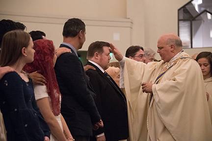 Monsignor Anthony Marcaccio, pastor, confirms one of the catechumens at the Easter Vigil Mass (Photo provided by MaryAnn Luedtke Photography)