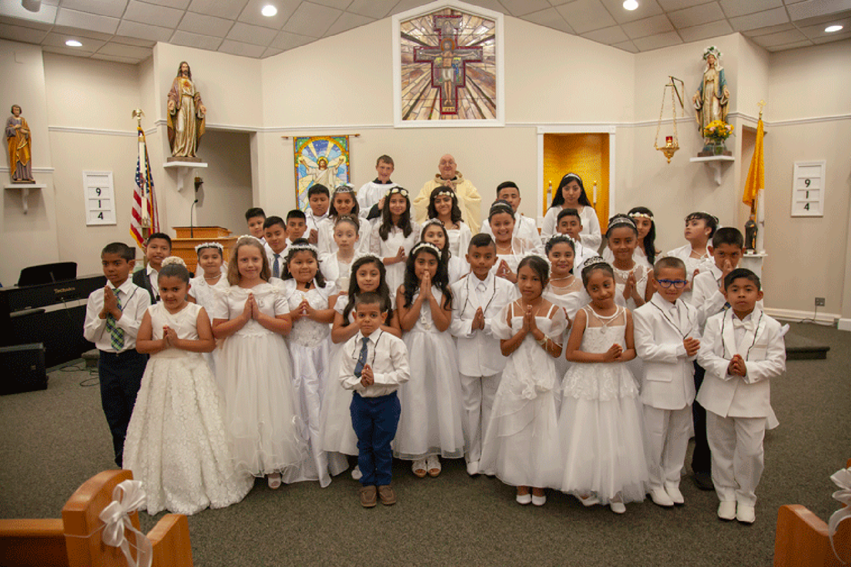 MOCKSVILLE — Thirty-two children received the sacrament of first Holy Communion May 5 at St. Francis of Assisi Church, during Mass offered by Father Eric L. Kowalski, pastor, and Father Christopher Ferger, MC. (Photo provided by David Taylor)