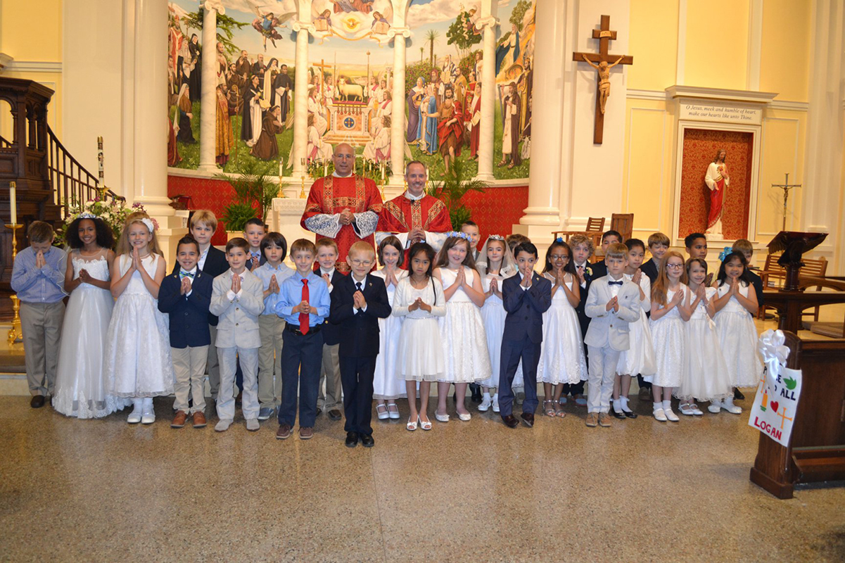 CHARLOTTE — Second-grade students at St. Ann School received the sacrament of first Holy Communion during Mass May 18 at St. Ann Church. They also honored the Blessed Virgin Mary with a May crowning. (Photo via Facebook)