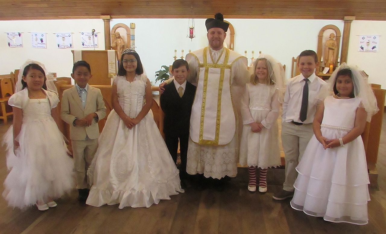 SYLVA — Seven children at St. Mary, Mother of God Church celebrated the sacrament of first Holy Communion May 6, during Mass offered by Father Casey Coleman, pastor. Pictured are: (from left) Paula Hernandez Longinos, Emmanuel Jaret Colex Longinos (Manny)
