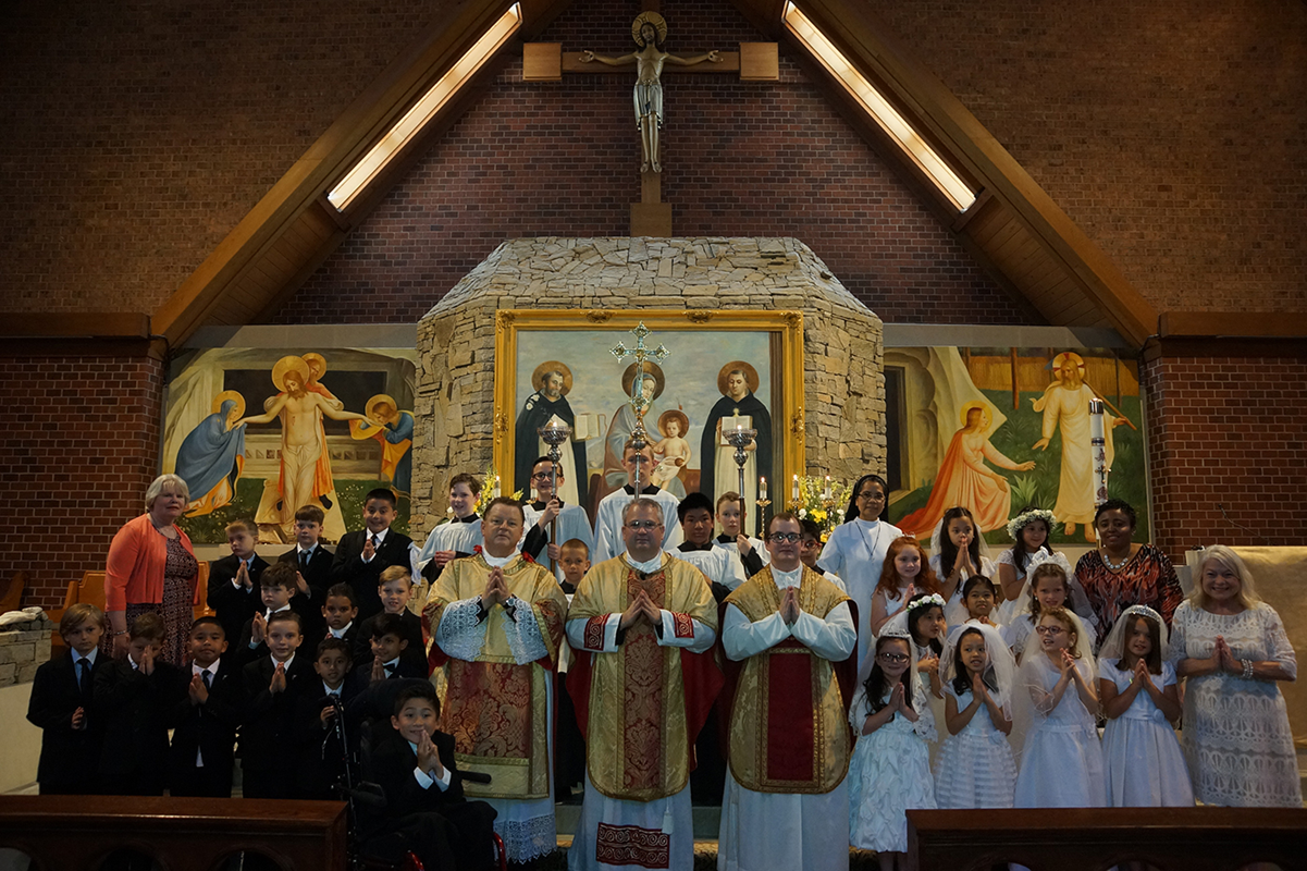 CHARLOTTE — Children at St. Thomas Aquinas Church received their first Holy Communion May 5 during Mass offered by Father Patrick Winslow, pastor, and Father Matthew Bean, parochial vicar. (Photos by John Cosmas | Catholic News Herald)
