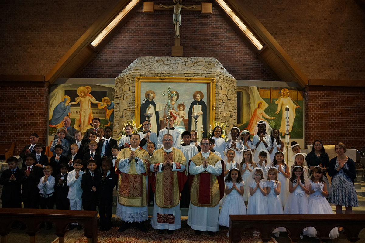 CHARLOTTE — Children at St. Thomas Aquinas Church received their first Holy Communion May 5 during Mass offered by Father Patrick Winslow, pastor, and Father Matthew Bean, parochial vicar. (Photos by John Cosmas | Catholic News Herald)