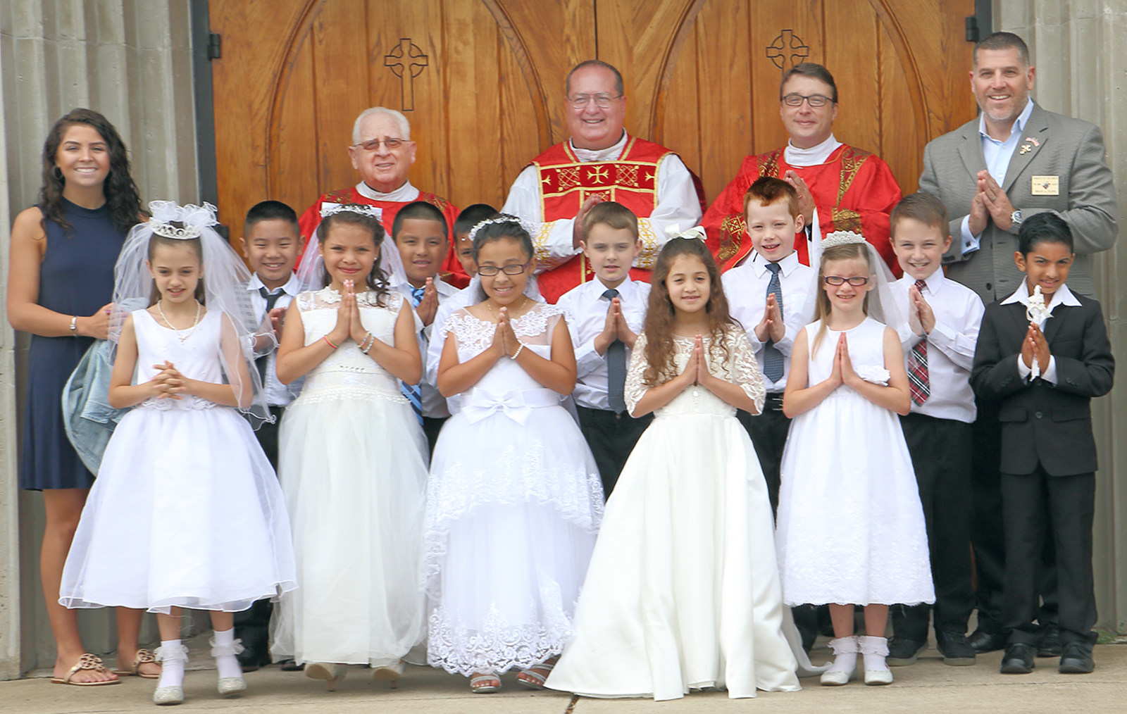 FOREST CITY — Thirteen young people received the sacrament of first Holy Communion at Immaculate Conception Church May 20, during the 9 a.m. Mass celebrated by Father Herbert Burke, pastor. (Giuliana Polinari Riley | Catholic News Herald)