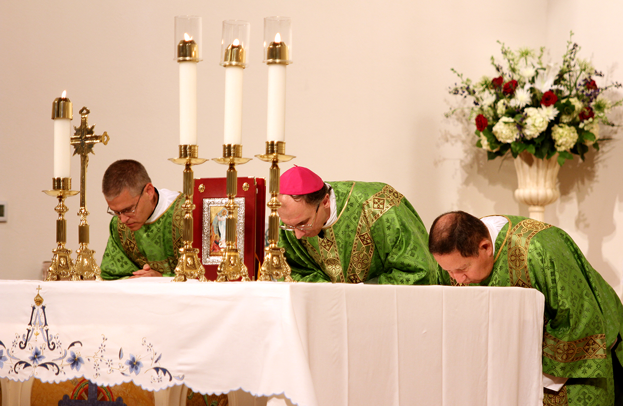 Bishop Peter Jugis celebrated the Mass, assisted by Deacon Paul Bruck (left) and Deacon Carlos Medina (right).