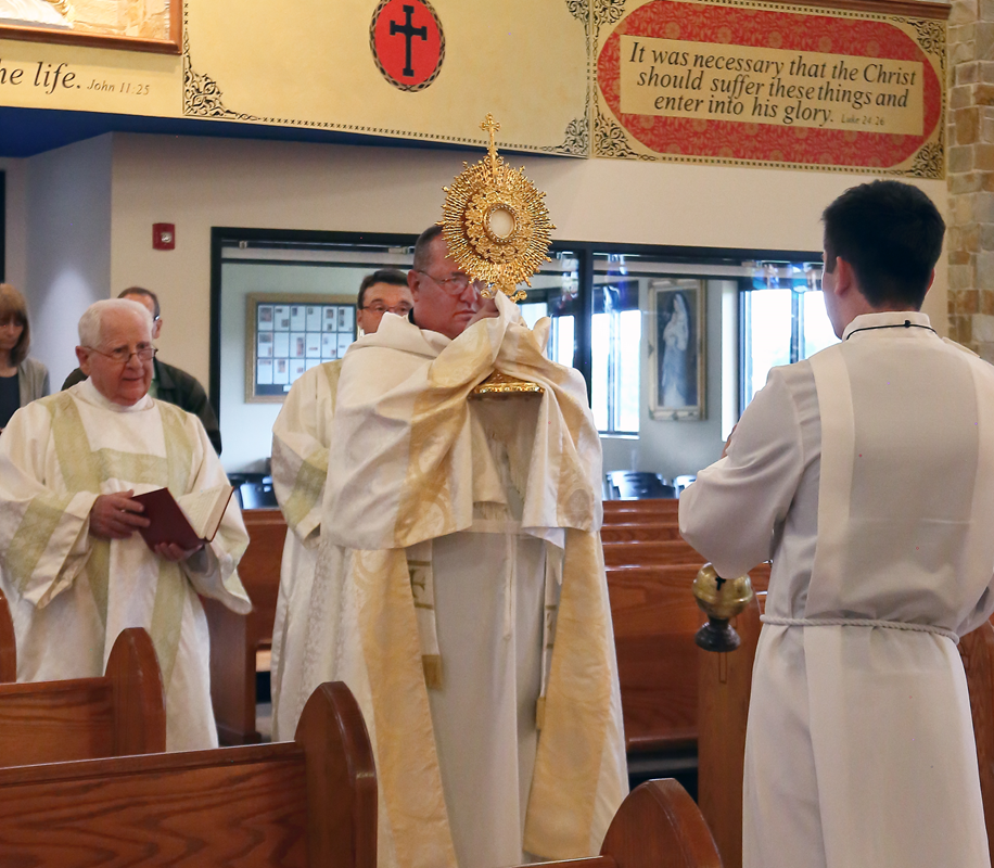 Corpus Christi procession with the Blessed Sacrament at Immaculate Conception Church in Forest City, led by Father Herbert Burke, pastor. (Photo by Giuliana Polinari Riley, Catholic News Herald)