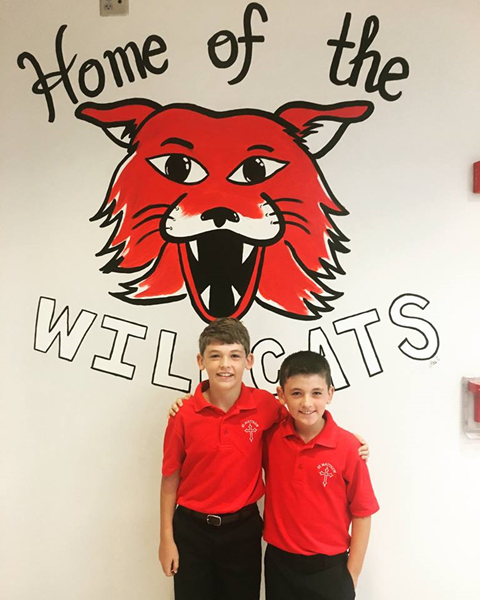 Two enthusiastic elementary students at St. Matthew School in Charlotte are all smiles on their first day of school Aug. 22.  Photo courtesy of St. Matthew School Facebook page.