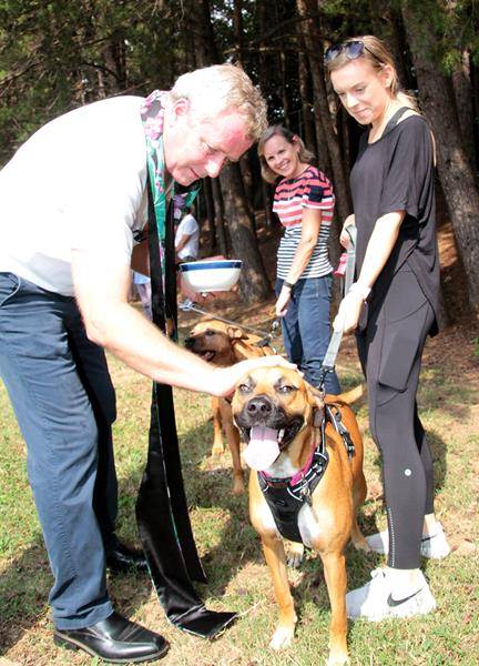On Oct. 6 Father Paul DeChant, pastor of Holy Cross Church, blessed animals at the parish, including Nina, pictured with its owner Katie Smith. The event in the church’s parking lot was presented by the parish’s evangelization committee. (John Bunyea | Ca