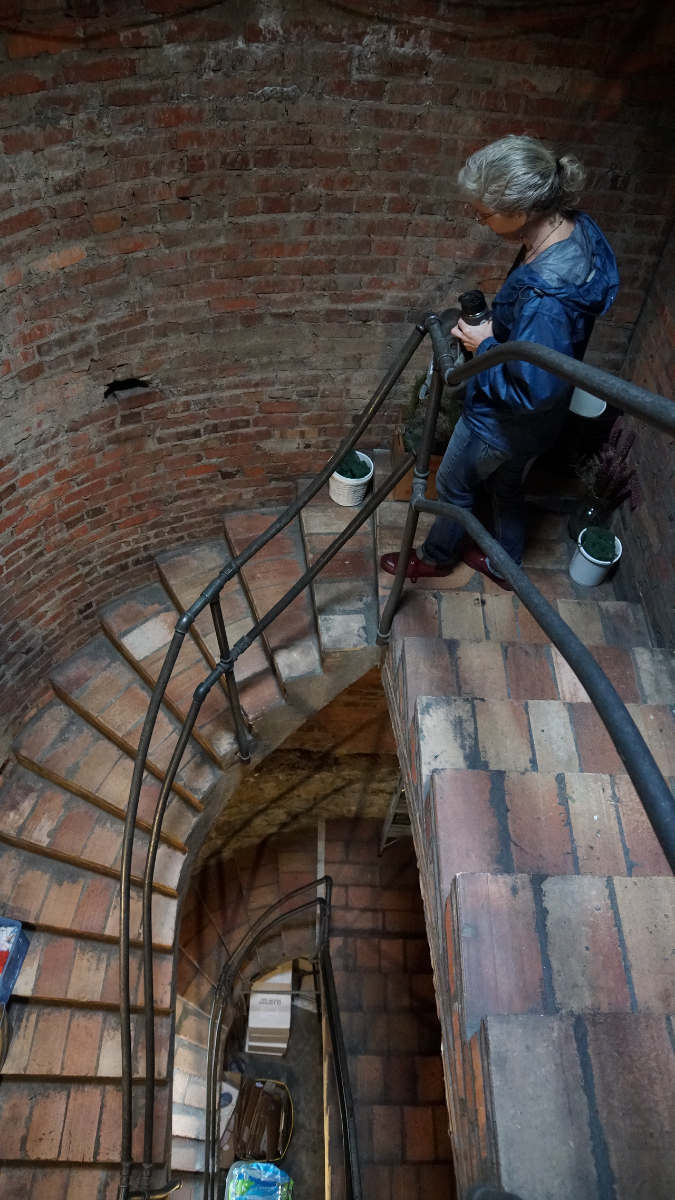Technicians survey the stairway leading to the basement and the stairs leading to the bell towers.