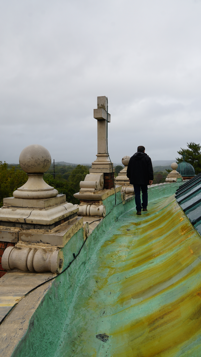 A technician walks along the edge of the basilica’s copper-clad dome. It is believed to be the largest unsupported elliptical dome in North America.