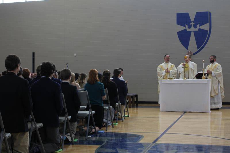 Bishop Peter Jugis (center) celebrates Mass Dec. 6 prior to blessing the new addition at Christ The King High School in Huntersville.
