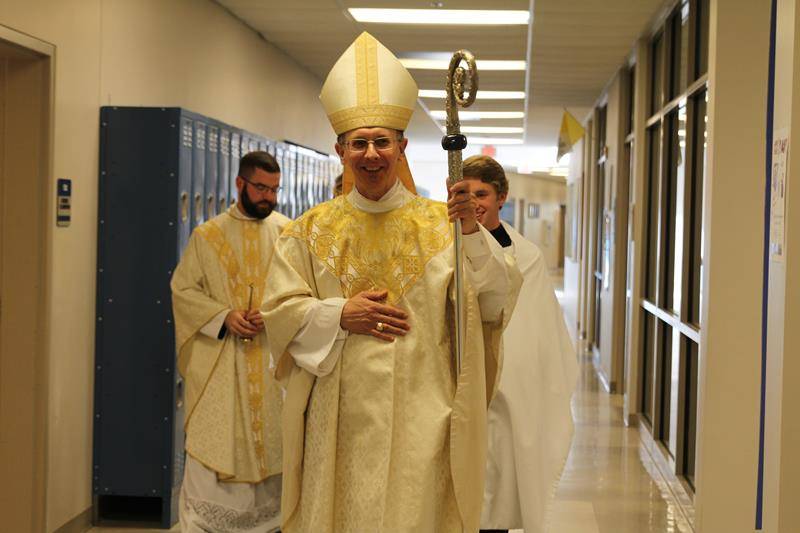 Father Paul McNulty (left) chaplain of Christ the King High School, walks with Bishop Peter Jugis as he heads to the ribbon cutting ceremony Dec. 6.
