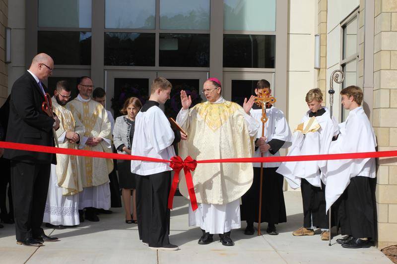 Bishop Peter Jugis offers prayers of blessing prior to the ribbon cutting.