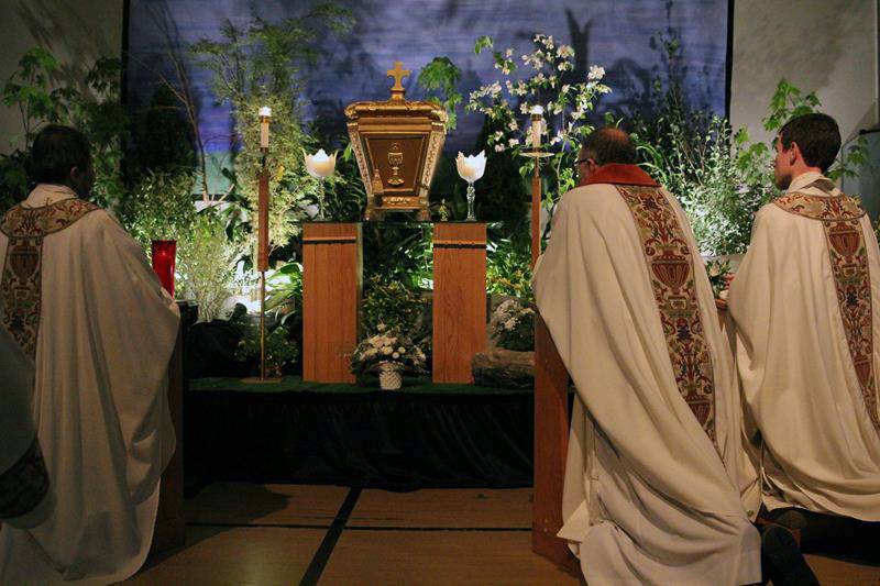 CHARLOTTE — Father Voitus, Deacon Tamayo and Father Catron kneel in front of the tabernacle at St. Vincent de Paul. (Photo by SueAnn Howell, Catholic News Herald)