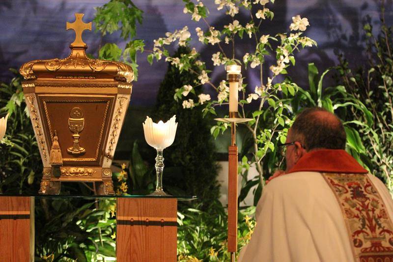 CHARLOTTE — Father Voitus, Deacon Tamayo and Father Catron kneel in front of the tabernacle at St. Vincent de Paul. (Photo by SueAnn Howell, Catholic News Herald)