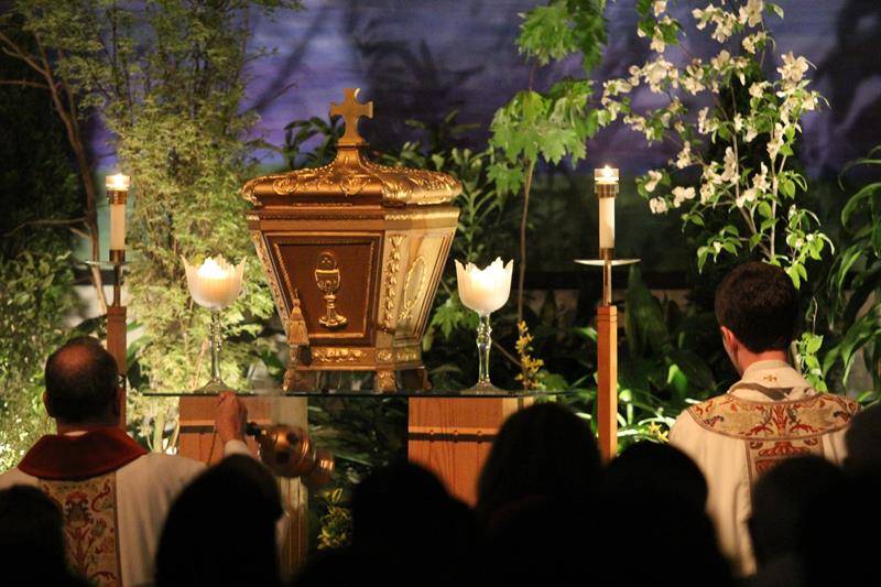 CHARLOTTE — Father Voitus, Deacon Tamayo and Father Catron kneel in front of the tabernacle at St. Vincent de Paul. (Photo by SueAnn Howell, Catholic News Herald)