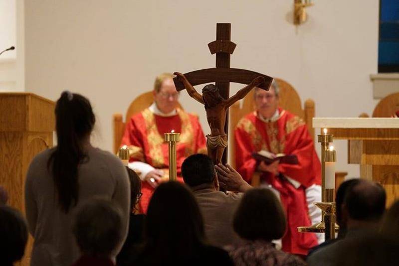 MOORESVILLE —Veneration of the Cross on Good Friday at  St. Therese Church. (Ohoto by John Cosmos, provided by Father Mark Lawlor)