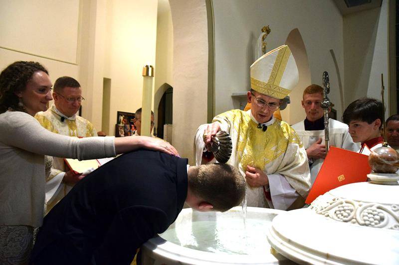 Bishop Peter Jugis performs a baptism during the Easter Vigil at St. Patrick Cathedral in Charlotte. (Photo by James Sarkis)