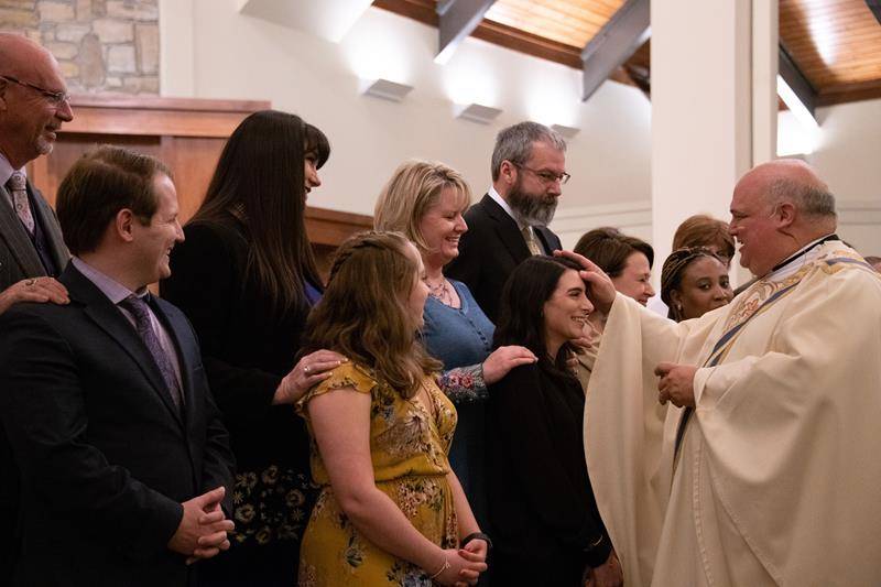 Monsignor Anthony Marcaccio confirms a catechumen during the Easter Vigil at St. Pius X Church in Greensboro April 20. (Photo by Mary Ann Luedtke)