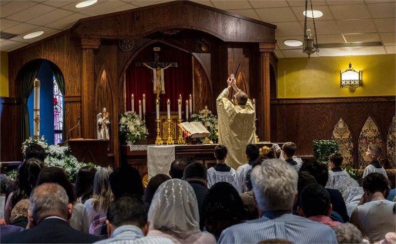 Father David Miller, pastor, elevates the Host during Easter Mass April 21 at St. Dorothy Church in Lincolnton. (Photo by Doreen Sugierski)