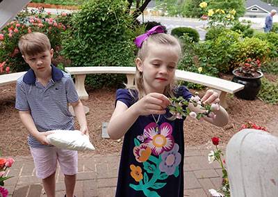 HUNTERSVILLE — St. Mark Preschool students Matthew Kelly-Bleiler and Ava McDonald crowned a statue of Mary May 3.  (Photo provided by Amy Burger)