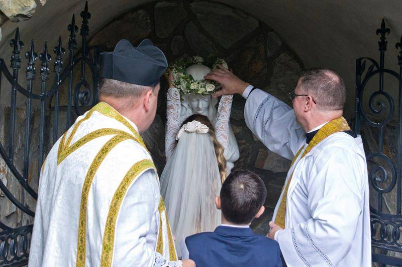 CHARLOTTE — First Communicants and children of St. Patrick Cathedral were invited to place flowers in a vase before the statue of Our Lady on Mother’s Day. Two of the First Communicants were chosen to crown her statue in the Marian grotto. 