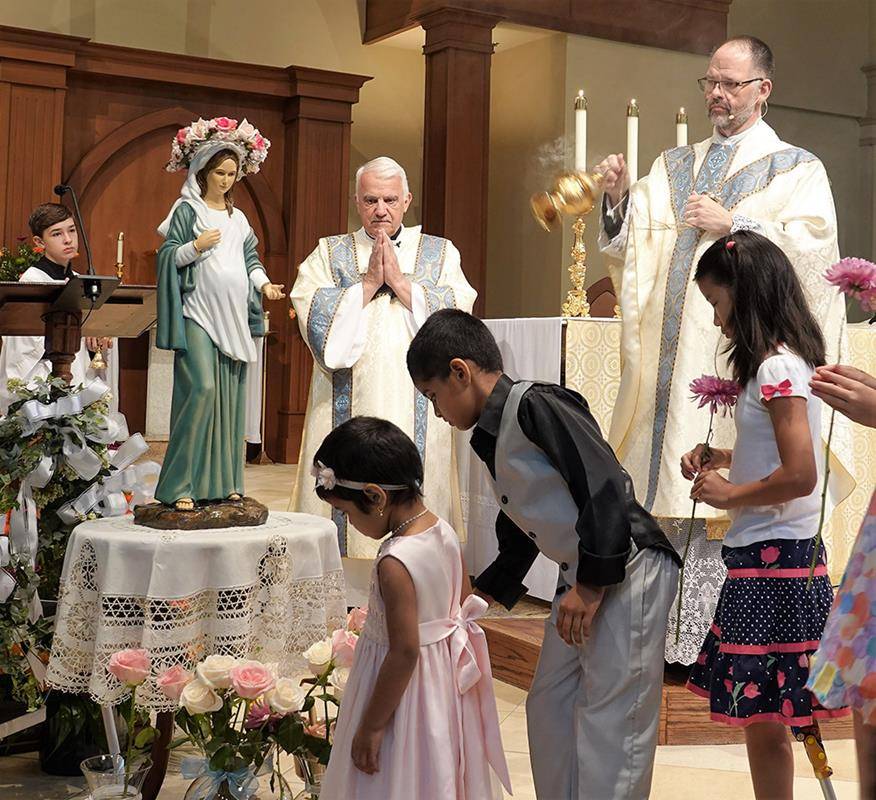 On May 12, children at St. Mark Parish also crowned a statue of Mary – a unique one that depicts her pregnant with Our Lord.