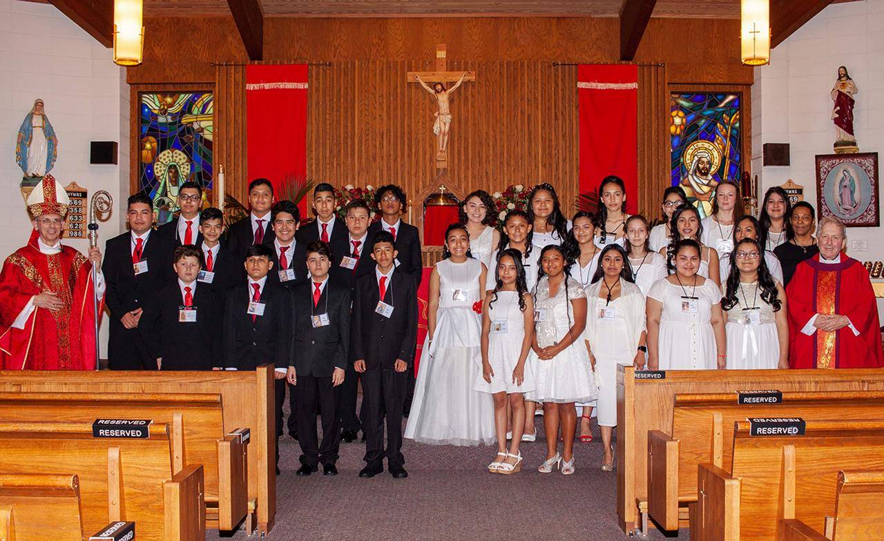 Twenty-nine young people received the sacrament of confirmation at Our Lady of the Angels Mission in Marion May 8, during Mass celebrated by Bishop Peter Jugis and Father Carl Kaltreider, pastor. (Photo provided by Michael Liga)