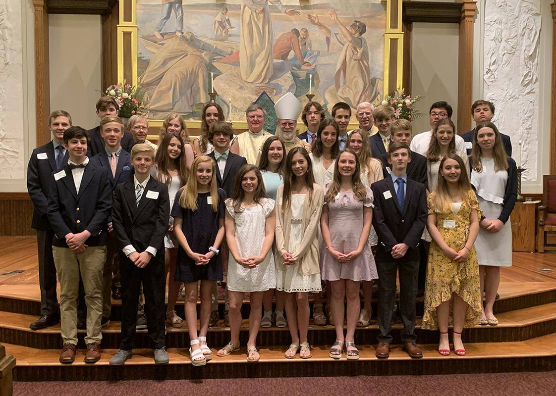 Young people at St. Peter Church in Charlotte received the sacrament of confirmation from Benedictine Abbot Placid of Belmont Abbey during Mass the weekend of May 11-12. (Photos provided by Cathy Chiappetta)