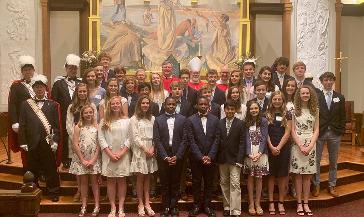 Young people at St. Peter Church in Charlotte received the sacrament of confirmation from Benedictine Abbot Placid of Belmont Abbey during Mass the weekend of May 11-12. (Photos provided by Cathy Chiappetta)