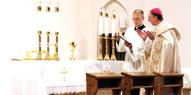 Bishop Jugis blessed each future priest's chalice which he will use at his first Mass on June 23. In the foreground are three kneelers that will be given to the new priests upon their ordination, a gift from Mary's Sons lay apostolate.