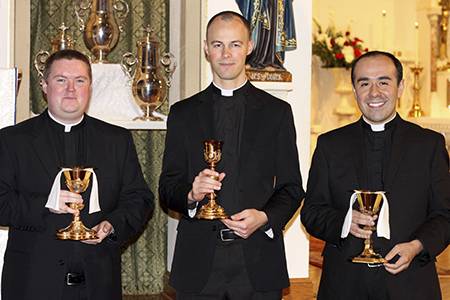 (From left) Deacons Britt Taylor, Michael Carlson and Alfonso Gamez Jr. hold their newly-blessed chalices after the Holy Hour.