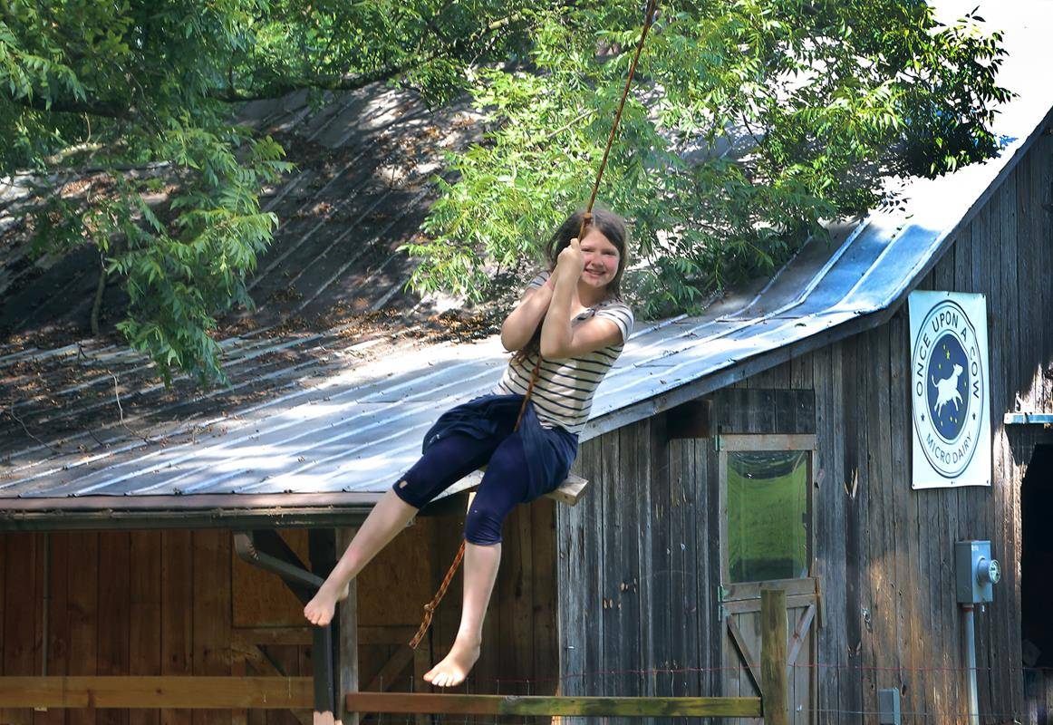 Flying over the barn on a rope swing (Copy)