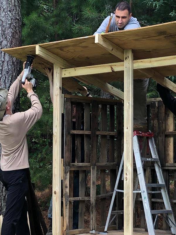 St. Joseph Workers provided hands-on help this summer. Here St. Joseph College seminarian Sebastian Alvarez Jaramillo splits wood during the project to build a wood shed. (Photos provided by Amy Burger) 