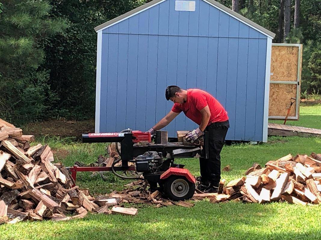 St. Joseph Workers provided hands-on help this summer. Here St. Joseph College seminarian Sebastian Alvarez Jaramillo splits wood during the project to build a wood shed. (Photos provided by Amy Burger) 