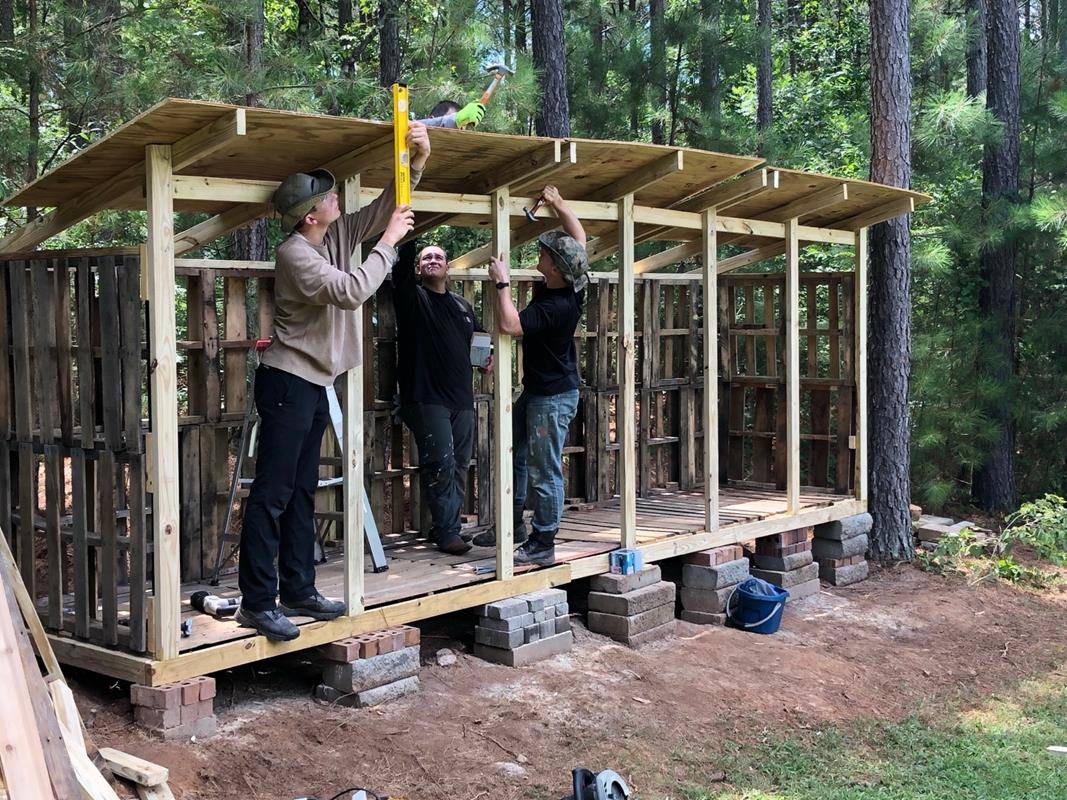 St. Joseph Workers provided hands-on help this summer. Here St. Joseph College seminarian Sebastian Alvarez Jaramillo splits wood during the project to build a wood shed. (Photos provided by Amy Burger) 