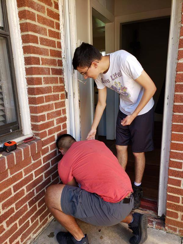 St. Joseph Workers provided hands-on help this summer. Here St. Joseph College seminarian Sebastian Alvarez Jaramillo splits wood during the project to build a wood shed. (Photos provided by Amy Burger) 