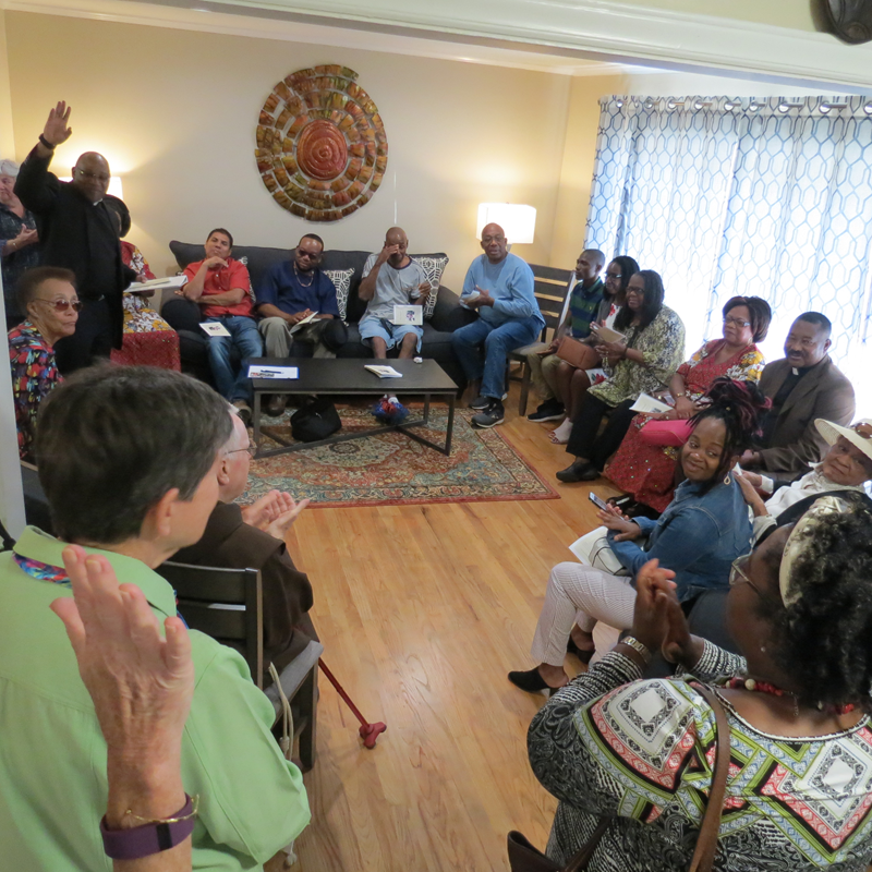 Father Amadi gives a blessing during the ceremony to open the new location. (Georgianna Penn, correspondent)