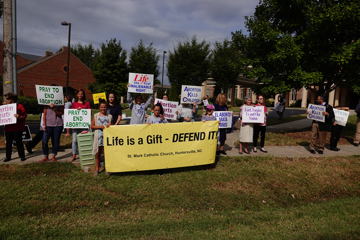 HUNTERSVILLE — More than 200 joined in a Life Chain along the sidewalk in front of St. Mark Church Oct. 6. After the Life Chain, the D3 Foundation Singers performed three of their pro-life songs. (Photos provided by Amy Burger)