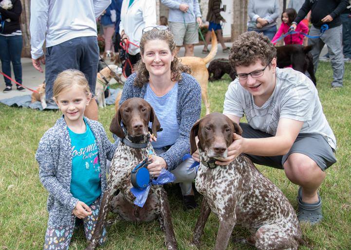 GREENSBORO —Peyton, Sandy, and Gavin Hill with their two German Shorthaired Pointers “Scout” and “Ranger” are blessed at St. Pius X Oct. 5. (Photos by MaryAnn Luedtke)
