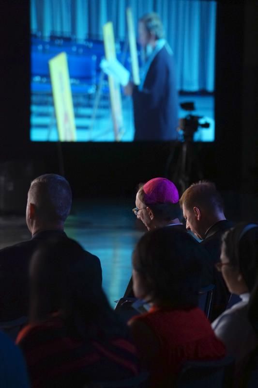 Bishop Peter Jugis listens as the band GK and the ChesterTones perform