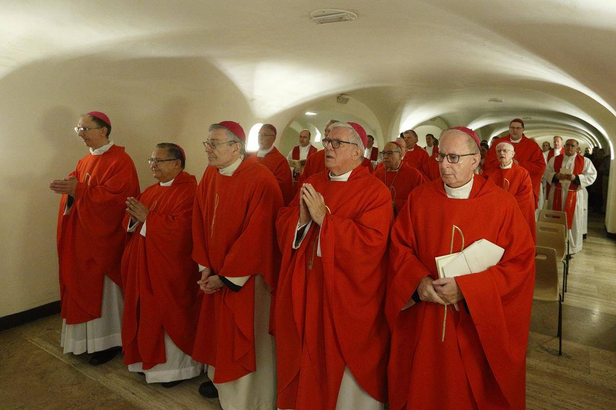 Archbishop Thomas J. Wenski of Miami, Fla., and other U.S. bishops pray as they concelebrate Mass in the crypt of St. Peter's Basilica at the Vatican Feb. 13, 2020. (CNS photo/Cindy Wooden)