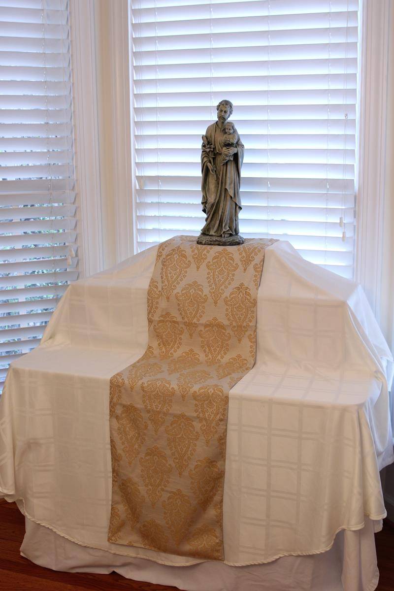 Empty table with St. Joseph statue a top.
